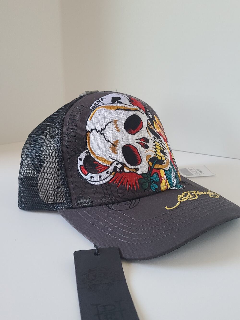 Now the tag is clear. This is an Ed Hardy by Christian Audigier trucker hat.